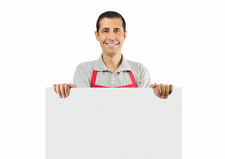 Shot of a shopman holding up a blank placard with white backgroundの写真素材
