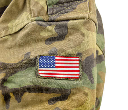 Cropped closeup shot  of the United States of America flag on a soldier's uniform with white backgroundの写真素材