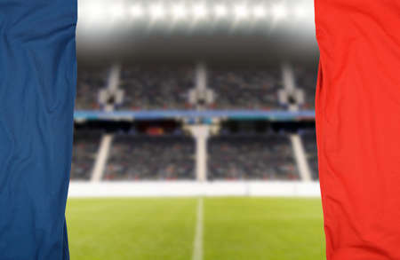 two shirts of red and blue football o soccer players teams with a background stadium out of focus with and copy spaceの写真素材