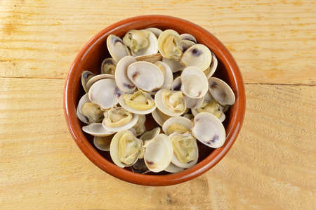 bowl with clams on a rustic tableの写真素材