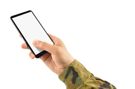 Man hand is holding a white modern smartphone with uniform military against a white background and copy space.の写真素材