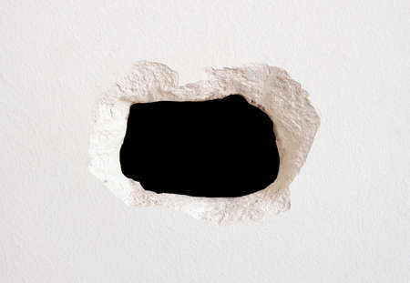detail of wall hole on a wall whiteの写真素材