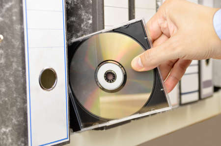 office worker picking up a data file from a filerの写真素材