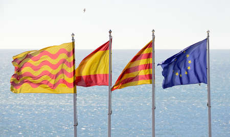 flags of tarragona, spain, catalonia and european union with a sea of backgroundの写真素材
