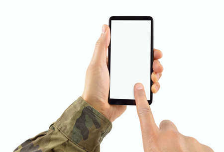 Man hand is holding a white modern smartphone with uniform military against a white background and copy space.の写真素材