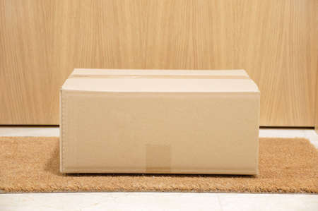 carton box on the floor of doorway homeの写真素材