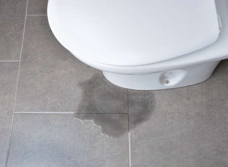 Leakage of water from a toilet due to blockage of the pipeの写真素材