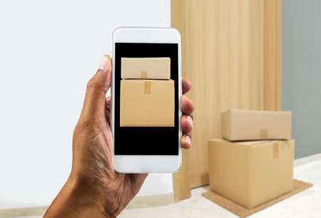 Fast delivery flat and black man with phone online.Fast shipping to the door of your house.の写真素材