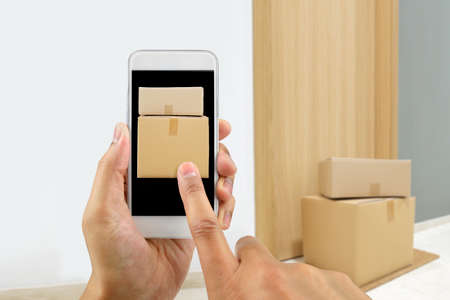 Fast delivery flat and caucasian man with phone online.Fast shipping to the door of your house.の写真素材