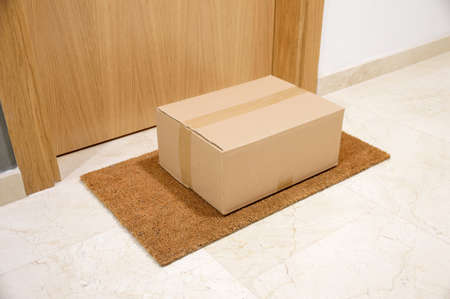 carton box on the floor of doorway homeの写真素材