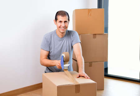 Shot of a man moving into her new house and looking at cameraの写真素材