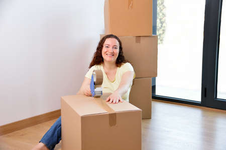 Shot of a young woman moving into her new house and looking at cameraの写真素材