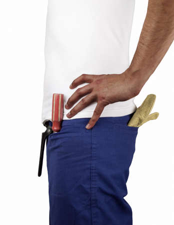 profile of building worker with tools in the pockets and hands on the hip over white backgroundの写真素材