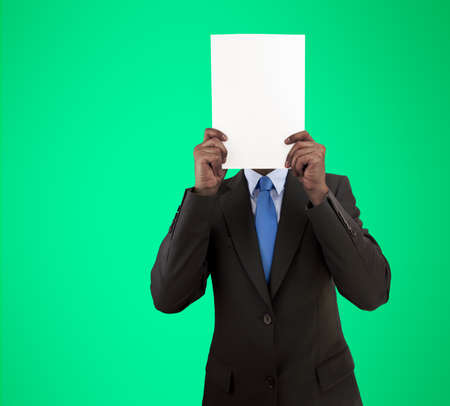 executive holding a placard in front of his face and isolated cutout on green backgroundの写真素材