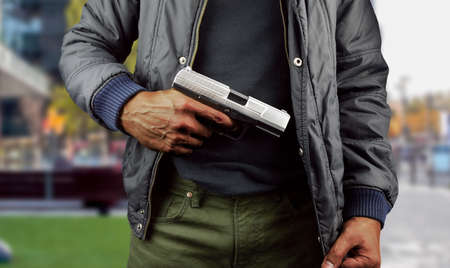 closeup of an armed terrorist with street backgroundの写真素材
