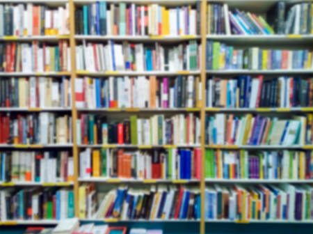 Blurred of bookshelves in the public library. Blurred effect Backgroundの写真素材