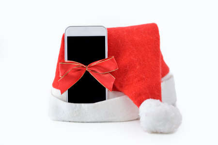 Close-up of phone christmas gift with a ribbon isolated on a white backgroundの写真素材
