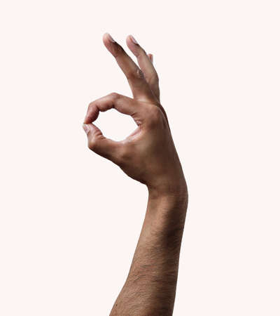 hand of an African man tossing a coin isolated on whiteの写真素材