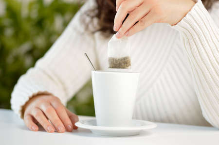 Closeup shot of an unrecognizable woman having a cup of teaの写真素材