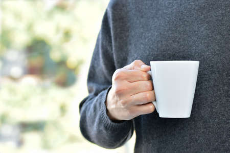 Hand of man holding a coffee cupの写真素材