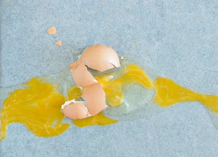broken egg on the kitchen floorの写真素材