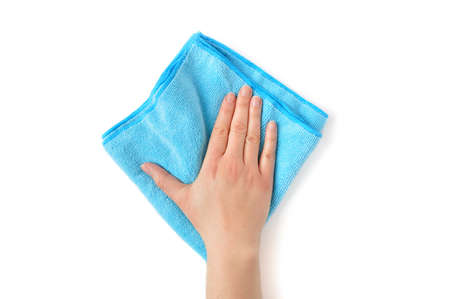 Hand wiping surface with blue rag isolated on whiteの写真素材