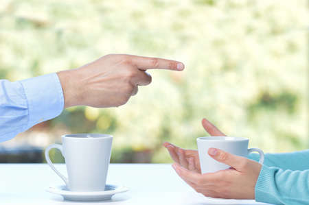 Close up of a friends hands arguing in a restaurant table の写真素材
