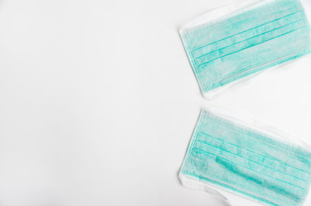 Flu prevention concept. Medical face mask on white background top view space for text frame