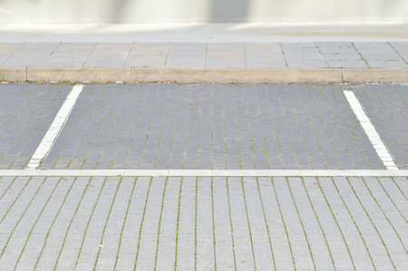 The parking stalls in a parking lot, marked with white lines