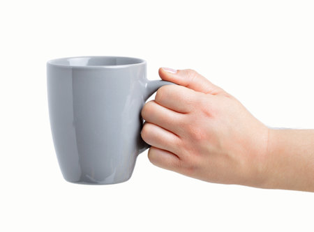 Closeup view of woman holding cup isolated on whiteの写真素材