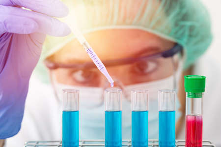Shot of a female scientist conducting medical research in a laboratory with focus on the test tubeの写真素材