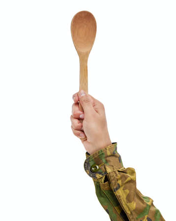 A chef arm holding wood spoon with white backgroundの写真素材