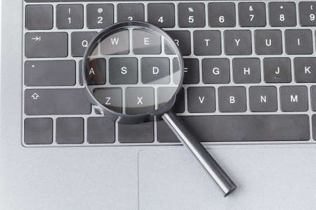 Magnifying glass on laptop. Internet search conceptの写真素材