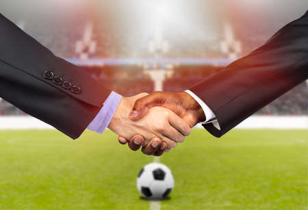 Cropped shot of two business people shaking hands together indoors on the soccer courtの写真素材