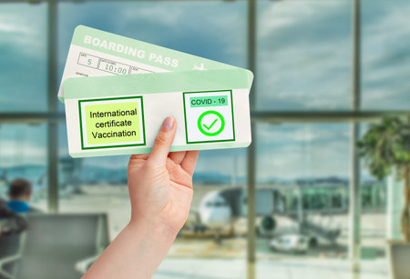 Person holding immunity passport at airport travel concept. New reality of post international travel...