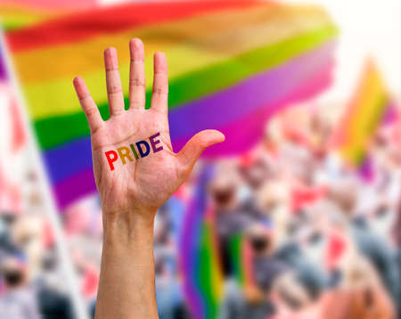 Gay guy's hand with a tattoo that says pride with white background. Symbol of sexual liberation and toleranceの写真素材