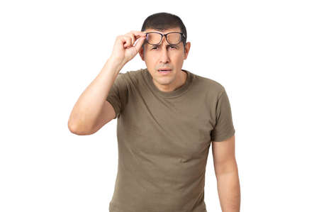 Mid adult with glasses straining his eyes because he can't see, isolated with white backgroundの写真素材