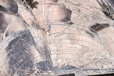 Detail of damage to windscreen of car shattered by vandalismの写真素材