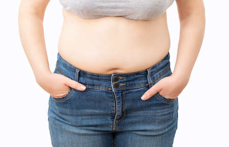 Close up of big belly of a fat woman with white backgroundの写真素材
