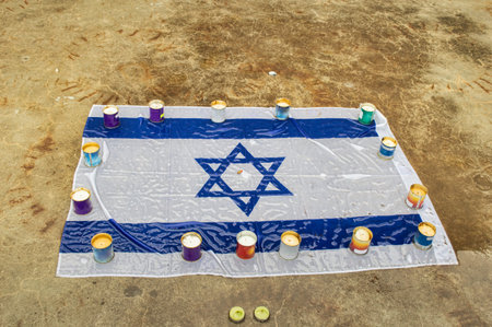 Mourning candles burning on Israel national flag background.Holocaust memory day. Moment of silence...