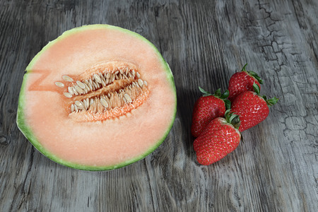melon and strawberry on wood backgroundの写真素材