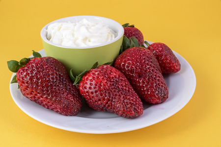 Strawberry cream on yellow の写真素材