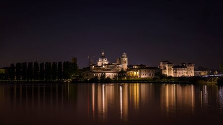 Mantua nightscape reflection on the riverの写真素材