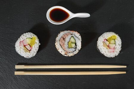 sushi pieces with soy sauce and chopsticksの写真素材