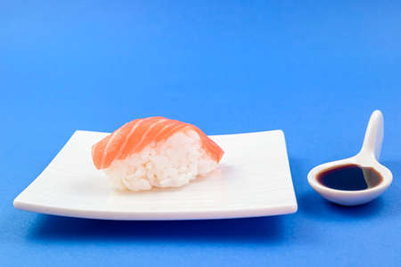 sushi and soy sauce on bluebackgroundの写真素材