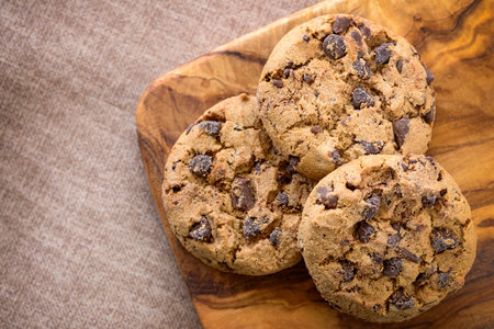 three american cookies on wooden table