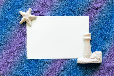 note on blue and violet sand with lighthouse and starfish