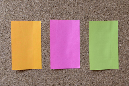 three color note on corkboardの写真素材