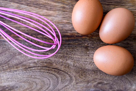eggs with beater on woodの写真素材