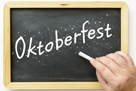 oktoberfest written on blackboard with female hand and chalkの写真素材